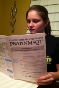 Sophomore Kailyn Bowman studies for the PSAT using the PSAT prep book. (file photo)