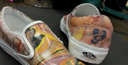 A plain white pair of Vans shoes were transofrmed into a music themed pair of shoes by a group of students in Zack Smitheys AP Studio Art class