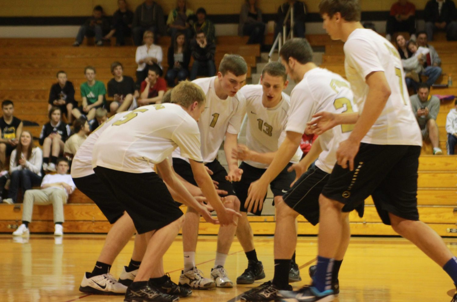 The Boys Varsity Volleyball team join together before their game on Tuesday, April 2. North took home a win against St. Dominic. Photo by Murphy Riley.