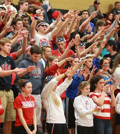 The crowd raises their arms to support FHNs boys varsirty team during a free-throw.