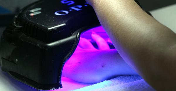 The UV lights starts to dry the nail polish. They use the UV lights to dry the gel nail polish because it helps the gel stay longer and become stronger. They dry each hand twice in one minute  increments. 