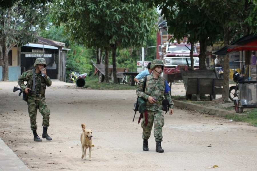 Two Colombian soldiers survey a village (Photo: Vlad Galenko, Shutterstock)