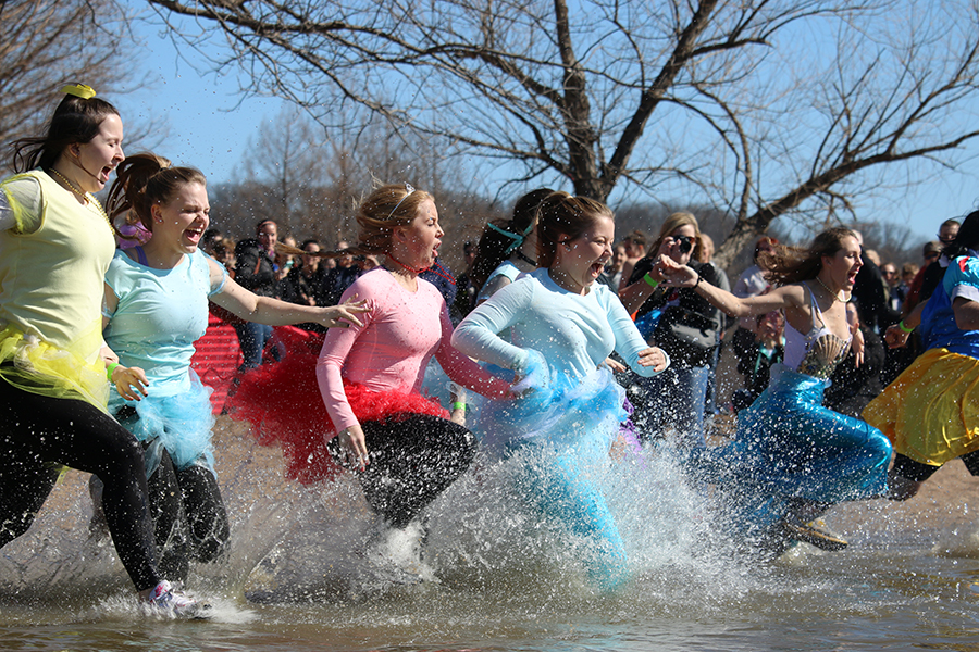 Graduates Brandi Wellman, Paige Ward, Madeline O’Laughlin, Lauren Wood, and Madison Vanek run into Creve Couer Lake in freezing cold temperatures on Feb. 27. The theme chosen for the last polar plunge was princesses and the participants from FHN were dressed in various Disney princess costumes.
