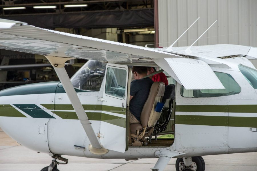 Senior Chase Meyer sits in the cockpit of his Cessna 172 with his instructor in May, 2015. They prepare for pre-flight checks of the aircraft before a storm rolls in from the north.