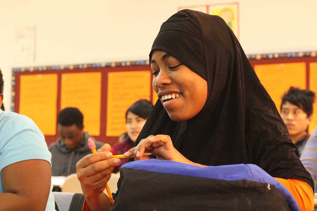 A 9th grade student at the Nahed Chapman Academy smiles after getting an answer correct. Students come into the Nahed Chapman New American Academy at various levels. They get to attend the school for two years, or until they can adapt successfully into American society. Some students have no concept of numbers when they first get to the school, but the staff is able to get the students where they want to be. 