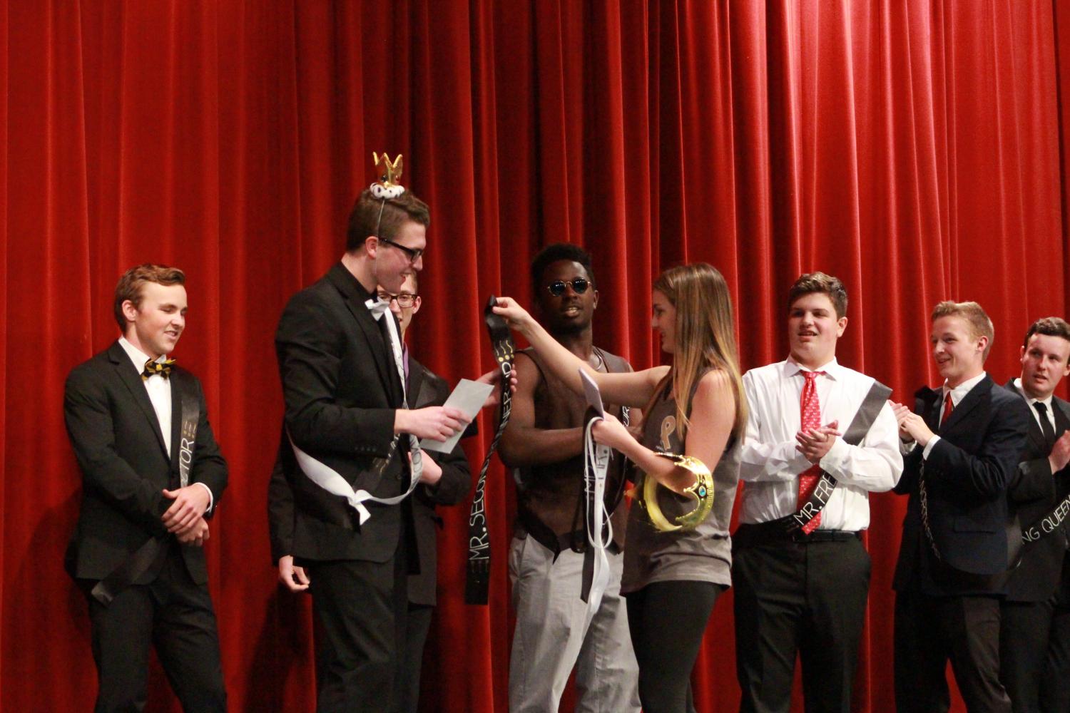 Junior Aaliyeh Habibi crowns senior Sean Rhomberg with second runner up and Mr. Congeniality. Rhomberg came in third place, while Zac Cary came in second place and Bryce Perry took first place. Each place was awarded a set amount of money, a sash and crown that they got to wear. 