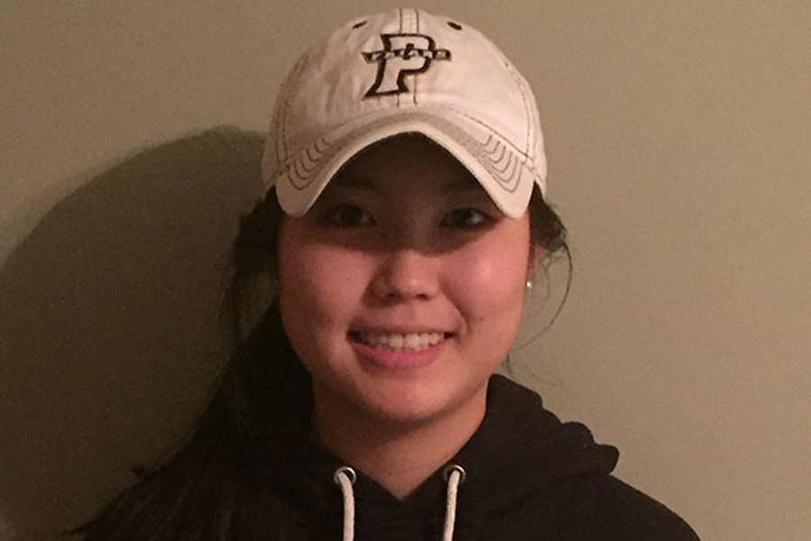 Senior Yuri Takenaka poses in a Providence University hat and hoodie. (Photo submitted)