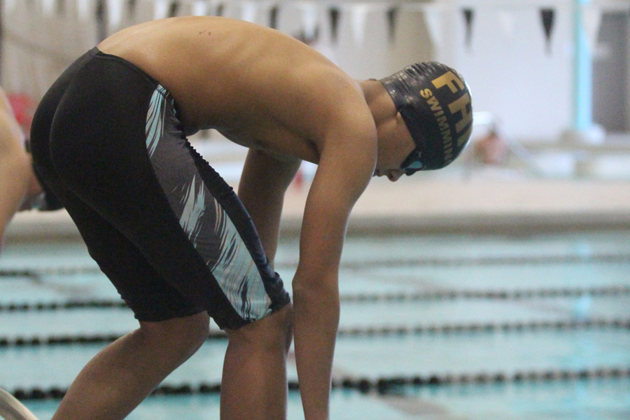 Junior Luke Davis prepares to dive into the water from the block. The boys’ diving and swimming team was cut this year due to a lack of swimmers and a coach. This decision could change in the future if more swimmers and divers try out.