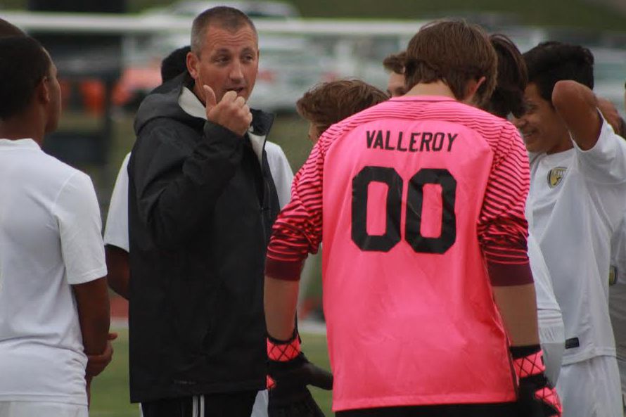 Coach Larry Scheller talks to the team during the soccer game vs Howell on Sept. 12.