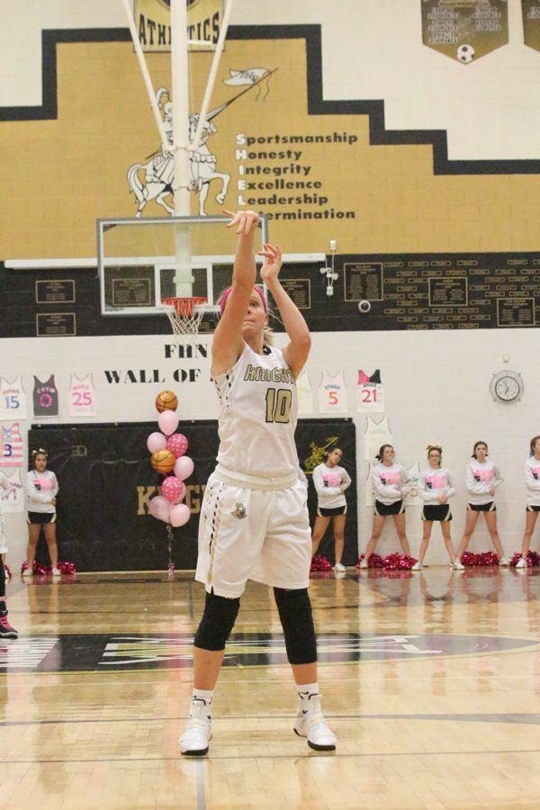 Junior Maddie Stock attempts to make a free through in a varsity girls basketball game. 