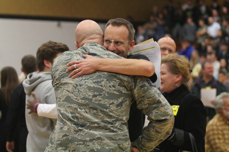 FHN Alumni Kenneth Kaibel embraces former Publications Adviser, Aaron Manfull. Kaibel was the guest speaker at FHNs first annual Veterans Day assembly on Nov. 10. (pictured in his Military uniform)
