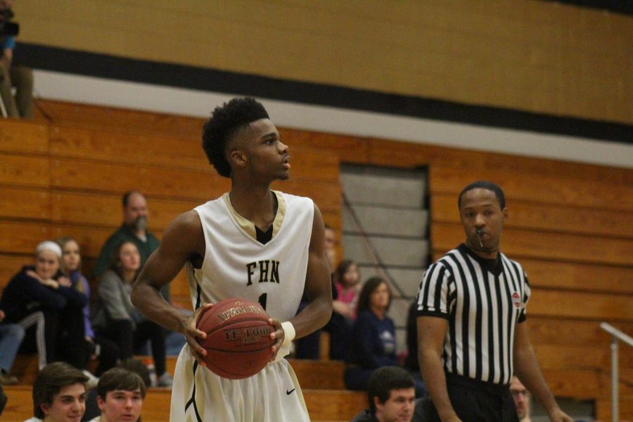 Senior Justin Mathews-Williams prepares to pass the ball on 3/3 in the Howell North gym.