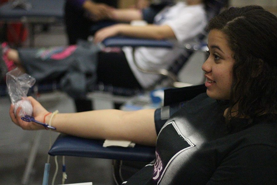 A student donates blood at the blood drive HOSA held in the big gym on Jan. 26. 