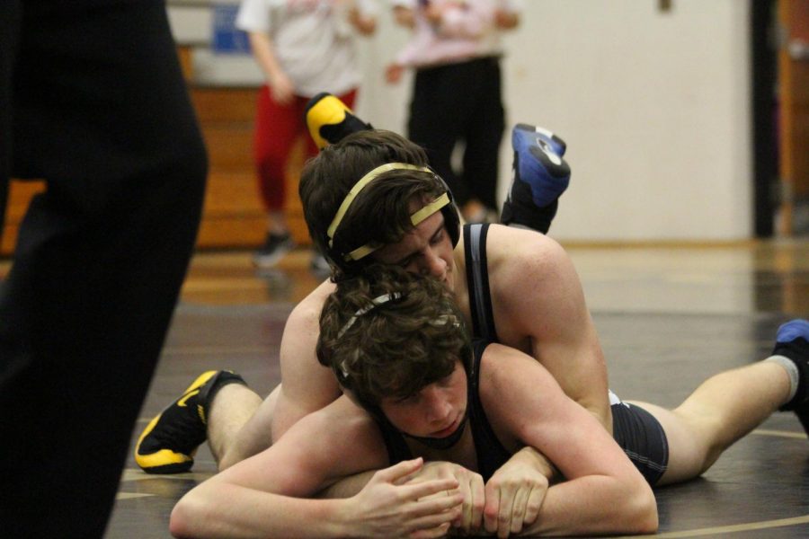 Senior Jacob Smith takes down opponent in a varsity dual in the Howell North Gym.