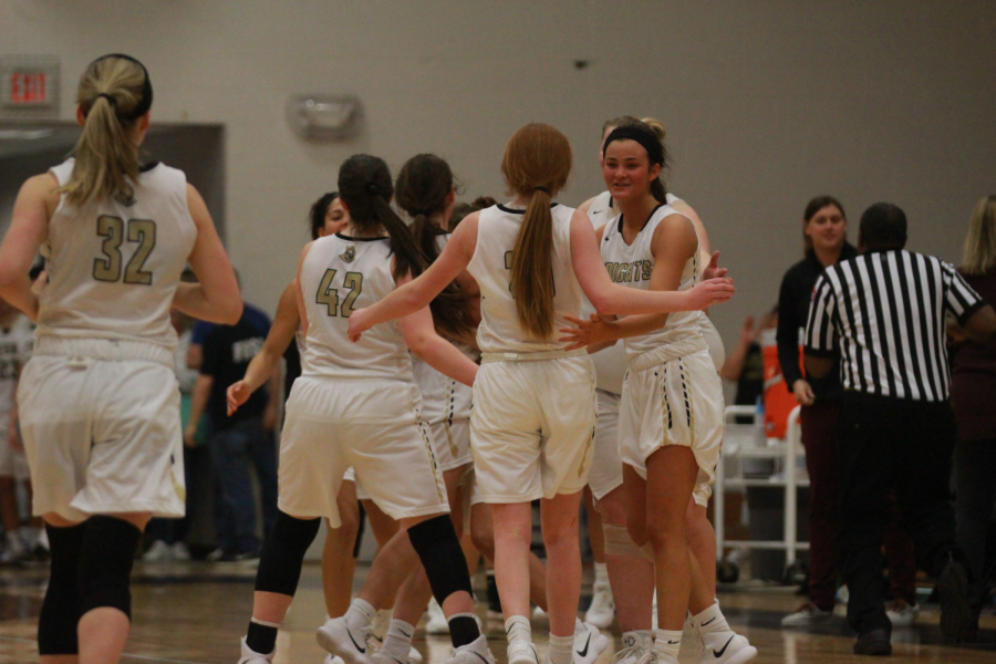 The Lady Knights head over to the bench during a timeout in their game against Timberland on 1/16. 