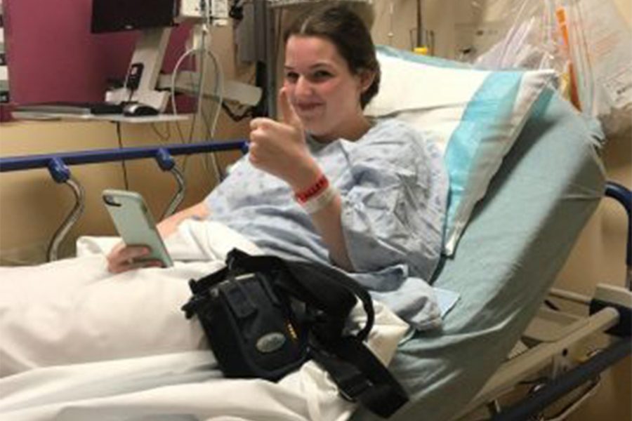 Senior Kailee Edelen sits in a hospital bed, before a surgery. (photo submitted)