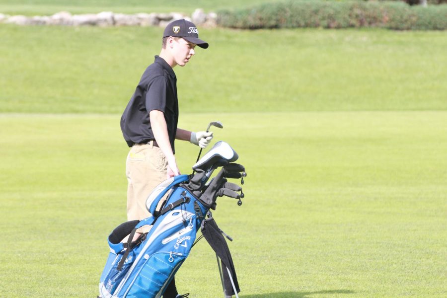 Senior Ben Harris selects a club on 4/25 against Francis Howell.