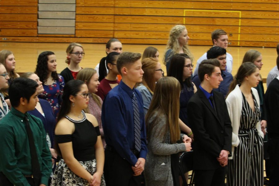 The National Honor Society inducted its new members in the large gym. Each inductee carried a small candle and placed it on a near by table. Some new members thought it was an honor to be in.