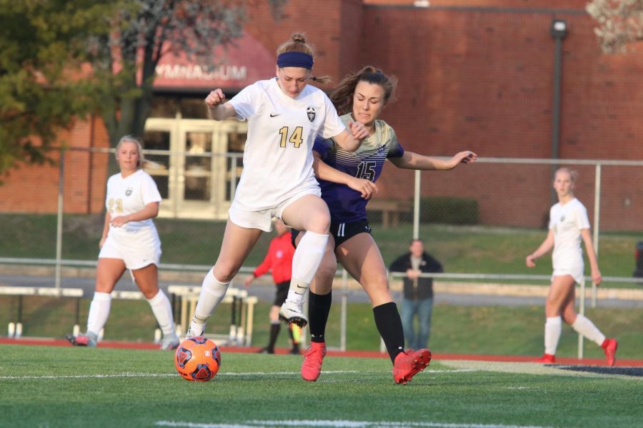 Senior Megan Crain takes on Troy defender Morgan Bova in a GAC South contest on 4/17 at Francis Howell North. The Trojans won the game by a score of 2-1. 