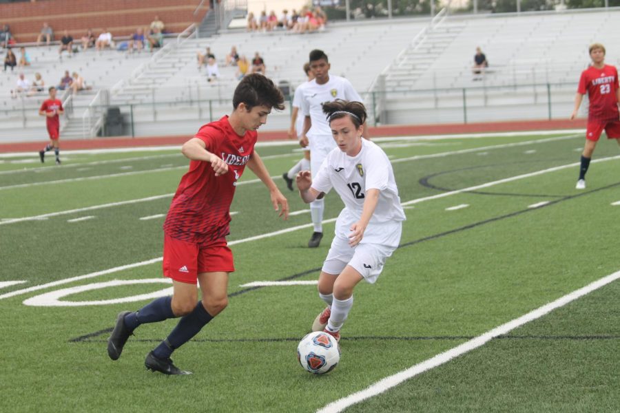 Freshman Cannon Murray attempts to regain possession of the ball in a match against Liberty High School.