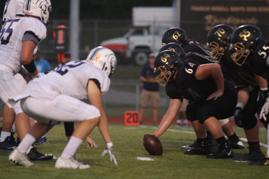 The Knights Football team prepares to snap the ball to the quarterback.