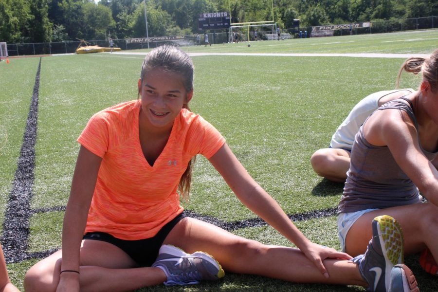 Sophomore Natalia Salazar stretches with her fellow cross country teammates at an after school practice. This is her seventh year running cross country and she has the ability to run a 7:50 minute mile. Salazar recently twisted her ankle during a practice and is unable to run for two weeks.