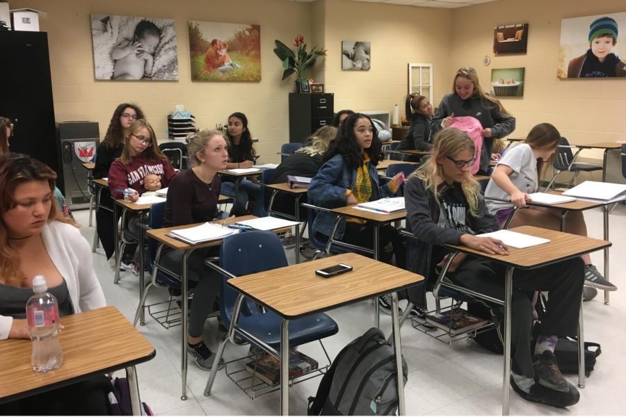 Students in Sara Whites Pathways to Teaching class, pull out their notes to continue their lesson from the previous day. In second semester, they will be able to participate in an internship at an elementary or middle school.