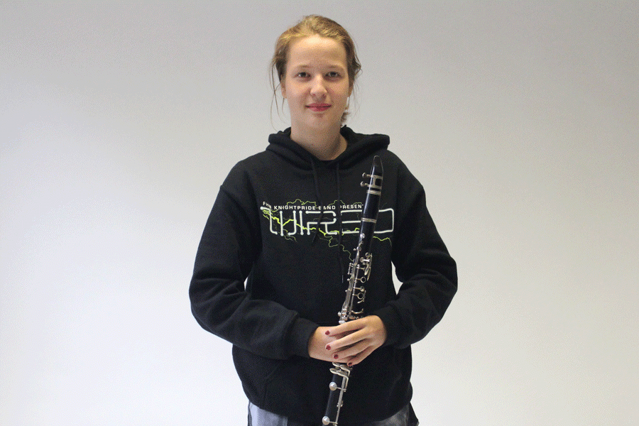 Sophomore Catherine Pundmann poses with her clarinet. After struggling with music, she improved by putting in extra time and effort.