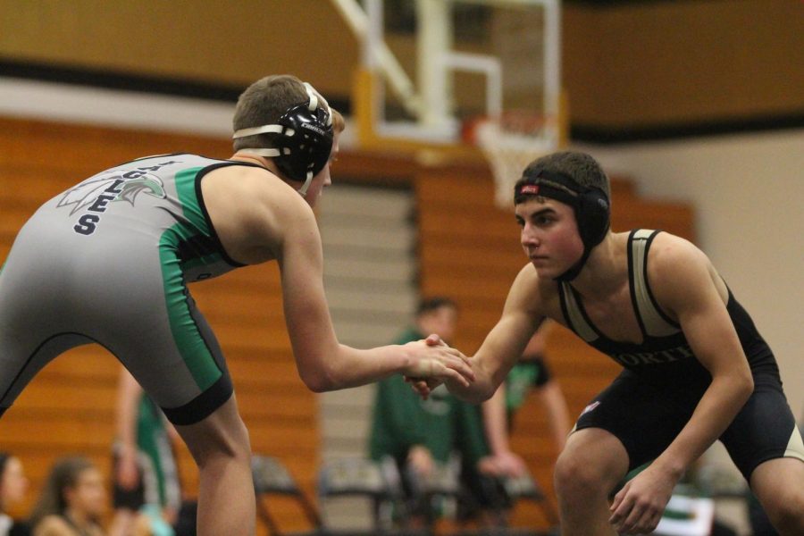 Freshman Mason Apple shakes hands with his opponent before a match in a try against OF and SCW.