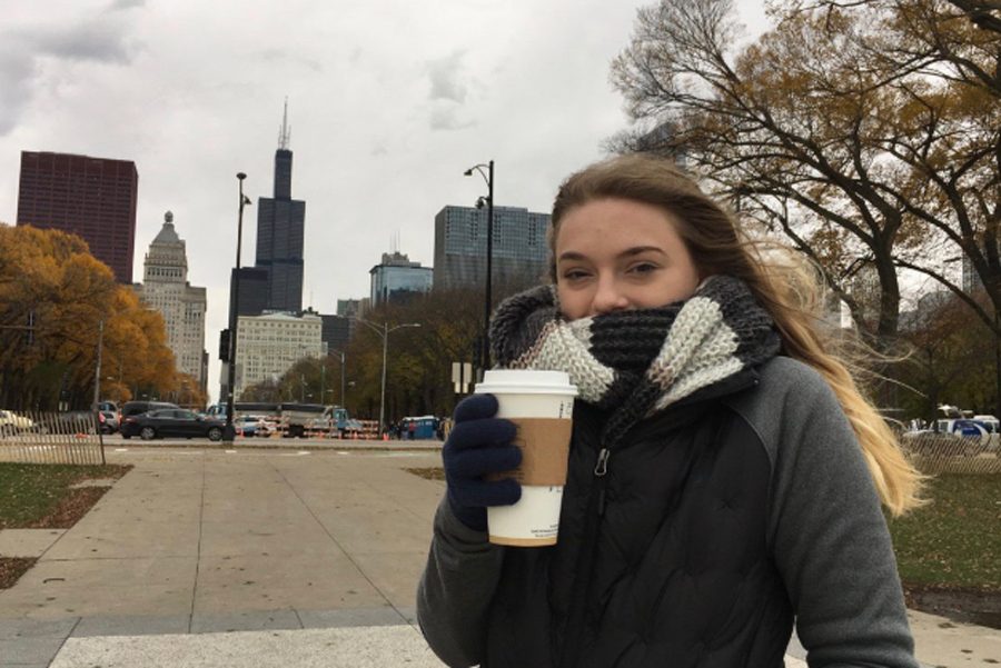 Senior Madi Shinault stands with her coffee in front of the Sears/Willis Tower in Chicago, IL.