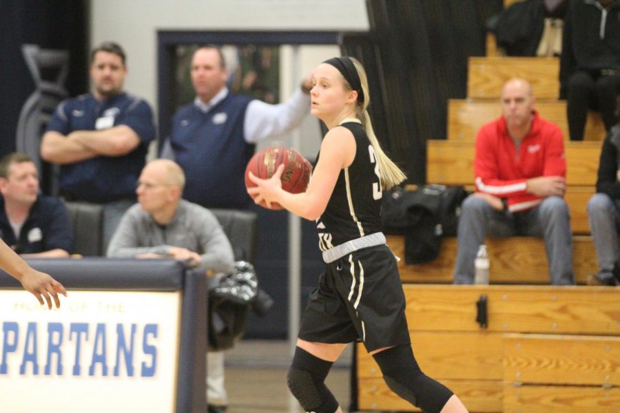 Senior+Maddie+Stock+prepares+to+pass+the+ball+to+one+of+her+teammates+in+a+game+against+FHC.