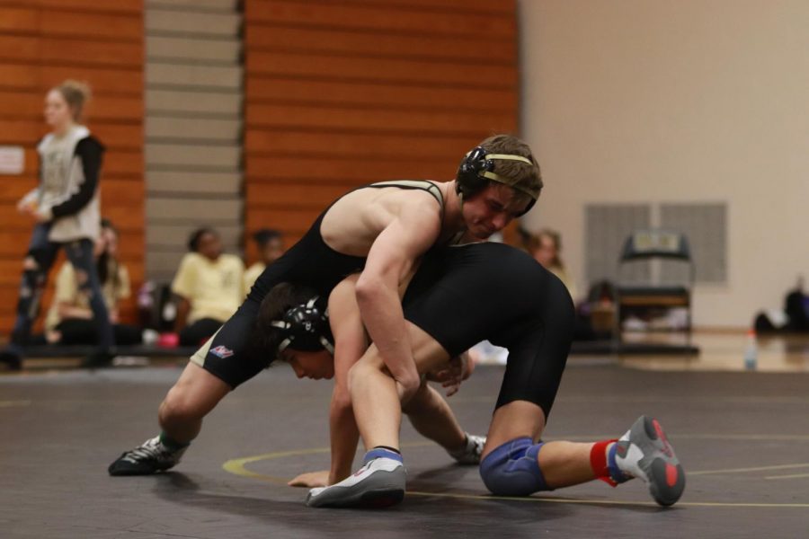 Senior Caleb Lumpkins attempts to pin a wrestler from Francis Howell