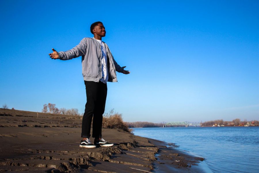 Sophomore AZ Anderson stands by the Mississippi River with his arms spread apart. Anderson was taught as a kid that he had to be independent, and he learned that lesson through many difficult experiences. Because of these trials, Anderson now lives with his grandparents, and he has started to live a more normal life.
