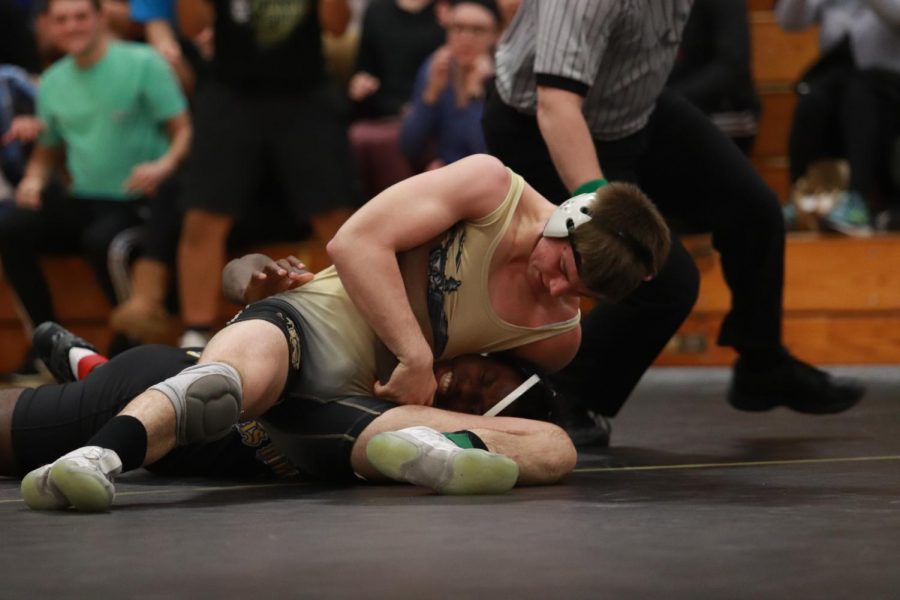 Senior Dillon Lauer looks to  pin his opponent in a duel against FHHS