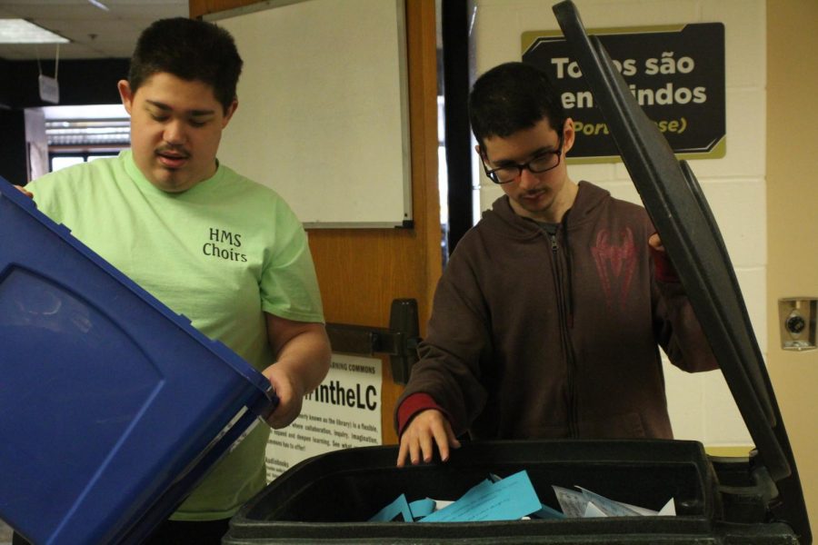 During seventh hour, Marquart and Oughton empty their last trashcan into the recycling bin under supervision of paraprofessional Scott Auchly. During their time spent recycling, Auchly coaches Marquart and Oughton on where to put plastic bottles and what classrooms have the fullest blue bins.