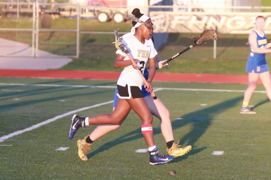 Senior Mya Huddleston runs alongside a FHHS player in an attempt to defend her. Huddleston will be playing lacrosse in college at Illinois Tech.