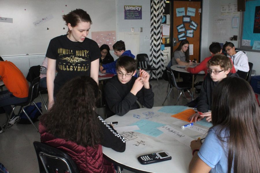 Math teacher Hannah Snyder-Laws, looks over students’ work during her Algebra class. The curriculum has students working together in teams to solve problems and complete the lesson for that day.