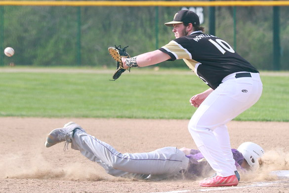 Junior Adam Lange catches ball at first base in game against Troy.