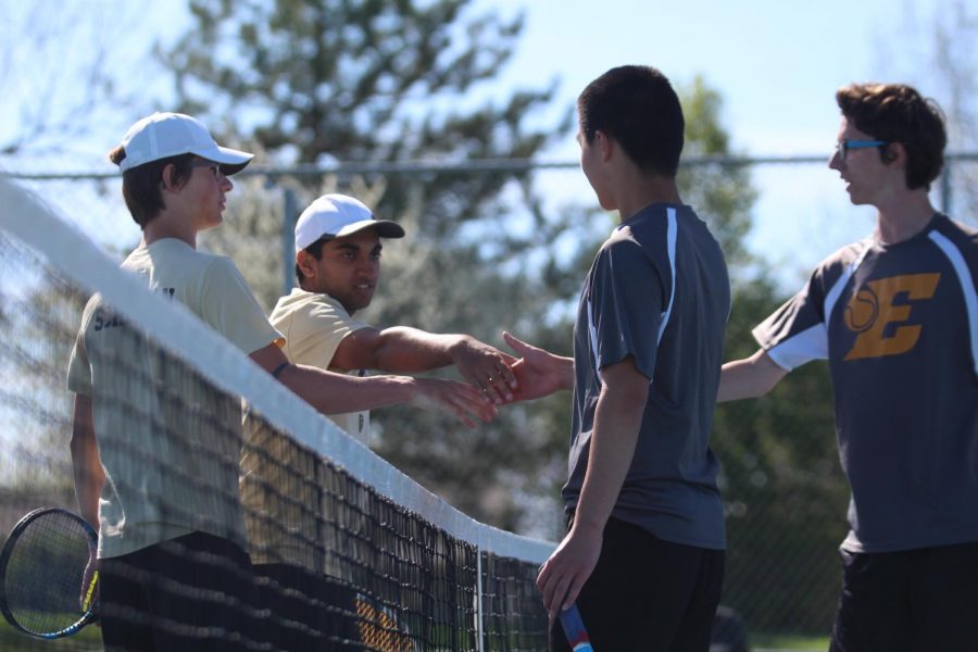 Senior Sachin Milli and junior Will Schellman shake hands with their opponents  after a match.