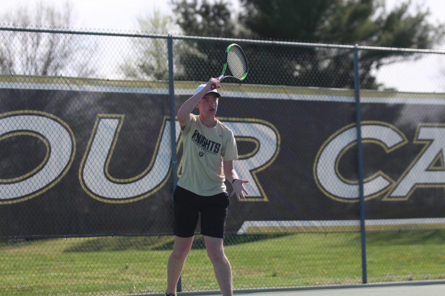 Sophomore Ben Ell swings his racket as he hits the ball. 