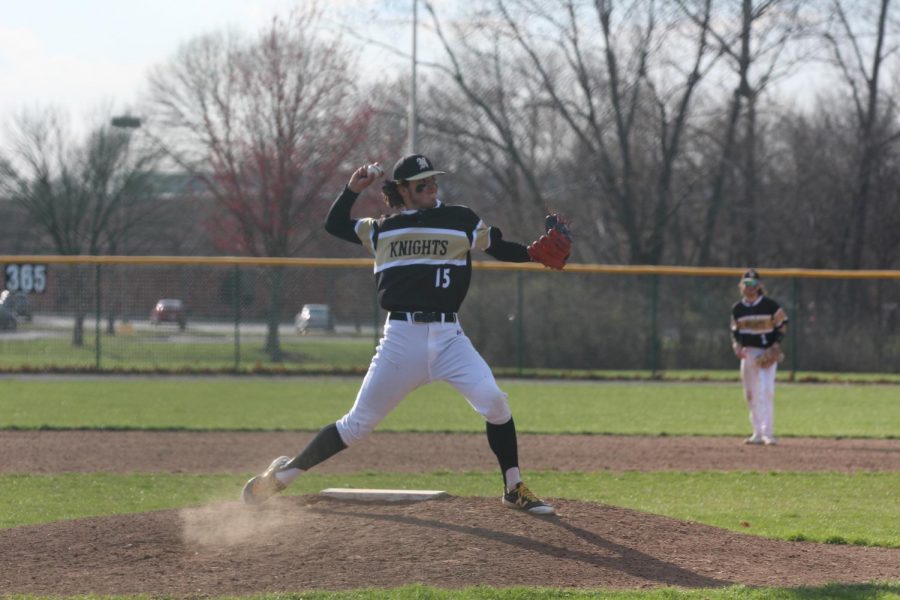 Sophomore Jackson Mitchell attempts to pick off a runner at first base during a game.