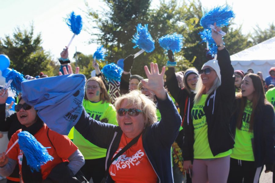 Participants in the crowd at the Autism Speaks Walk cheer for a guest speaker. The event had multiple guest speakers including Fox 2 New co-anchor Margie Ellisor. The event also had multiple organizations that donated money for autism research.
