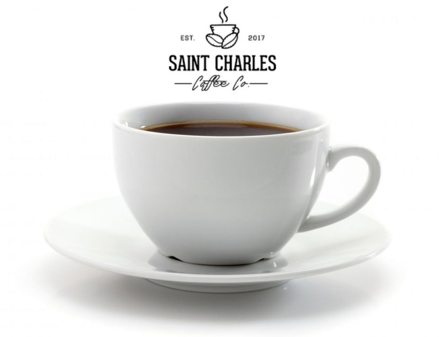 A cup of coffee sits on a plate with the logo of the new St. Charles Coffee Company above. The company was established in 2017 as a pop-up coffee shop in the St. Louis area and they pride themselves on donating profits to a charity of their choice. (Photo Illustration by Ella Manthey)