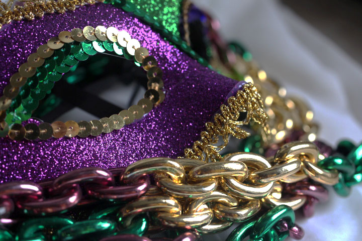 A Mardi Gras mask lays within a pile of beads in preparation for a parade. The neighborhood of Soulard will host this year’s Mardi Gras parade on Feb. 22. The theme for the event will be “The Blues.” 