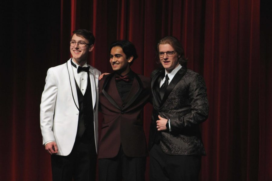 Louis Primeau, Tanay Parwal and Tom Jamison all show off their prom attire while laughing with their arms around each other. 