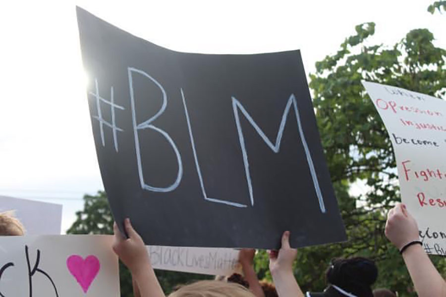 Protestors hold posters at a protest on Main Street, St. Charles, in support of the Black Lives Matter (BLM) movement. (Photo by Kaili Martin)