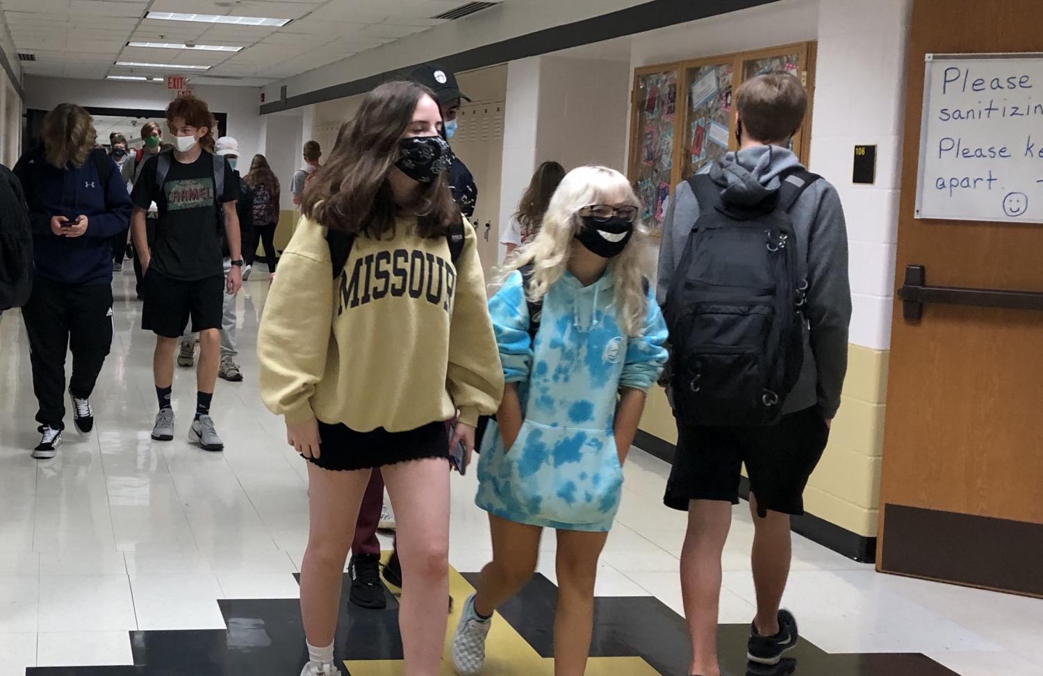 Students walk through the halls during passing period, wearing masks as per COVID-19 school protocol.