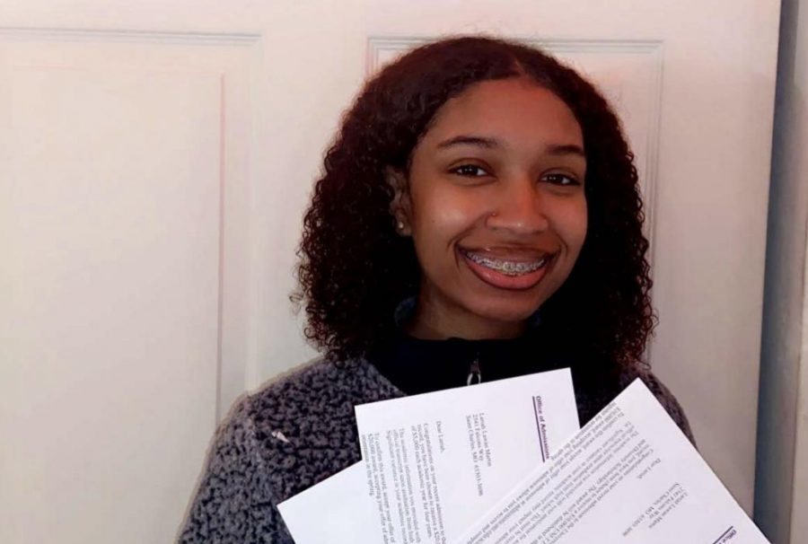 Lariah Martin poses with her scholarship letters from the University of Northern Iowa.