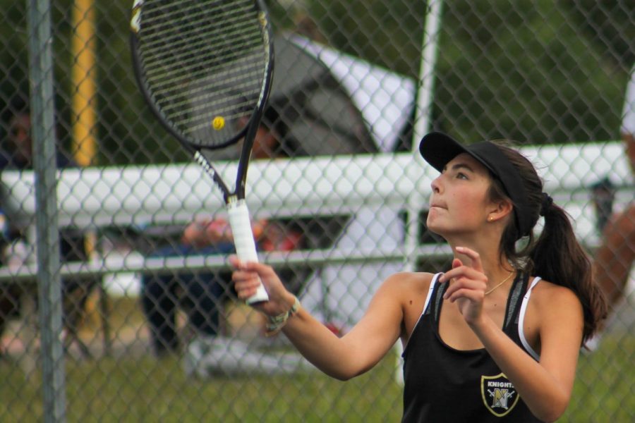 Maggie Koester hits the tennis ball during a tennis competition.