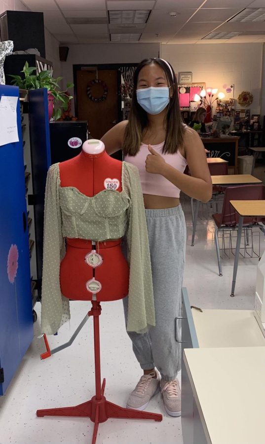 Sophomore Hailey Zhang stands next to a project she created. 